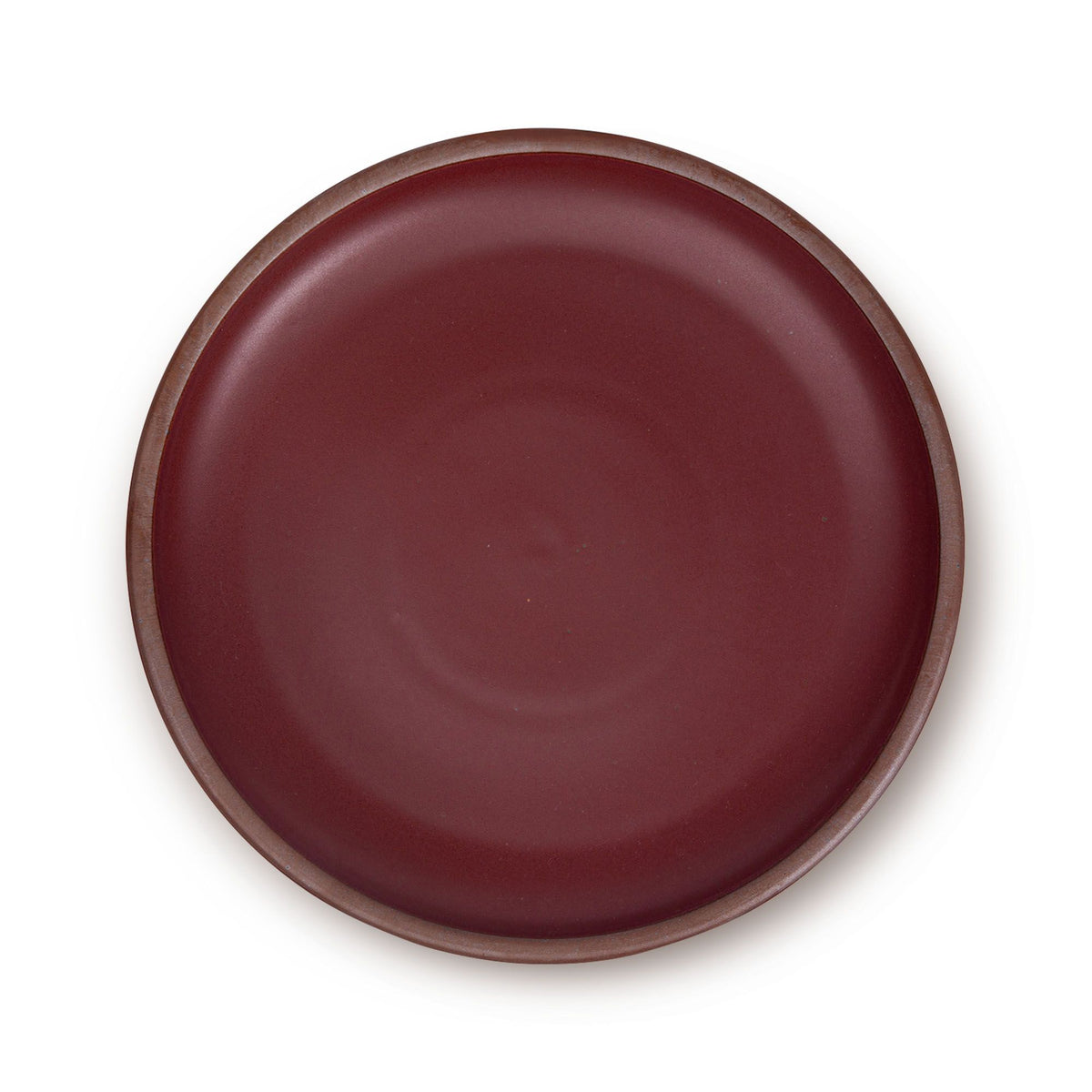 A large ceramic platter in a warm plum color featuring an unglazed rim.