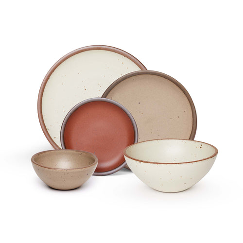 An ice cream bowl and side plate in a warm pale brown, a soup bowl and dinner plate in a warm off white, and a cake plate in a cool terracotta color.