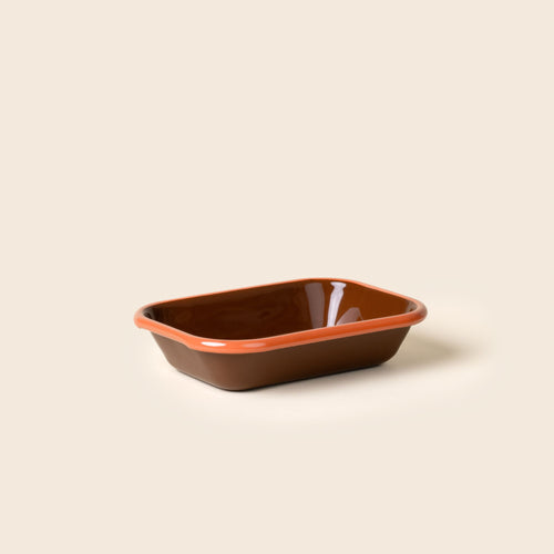 Small rectangular baking dish in a dark red-brown color with an orange rim.