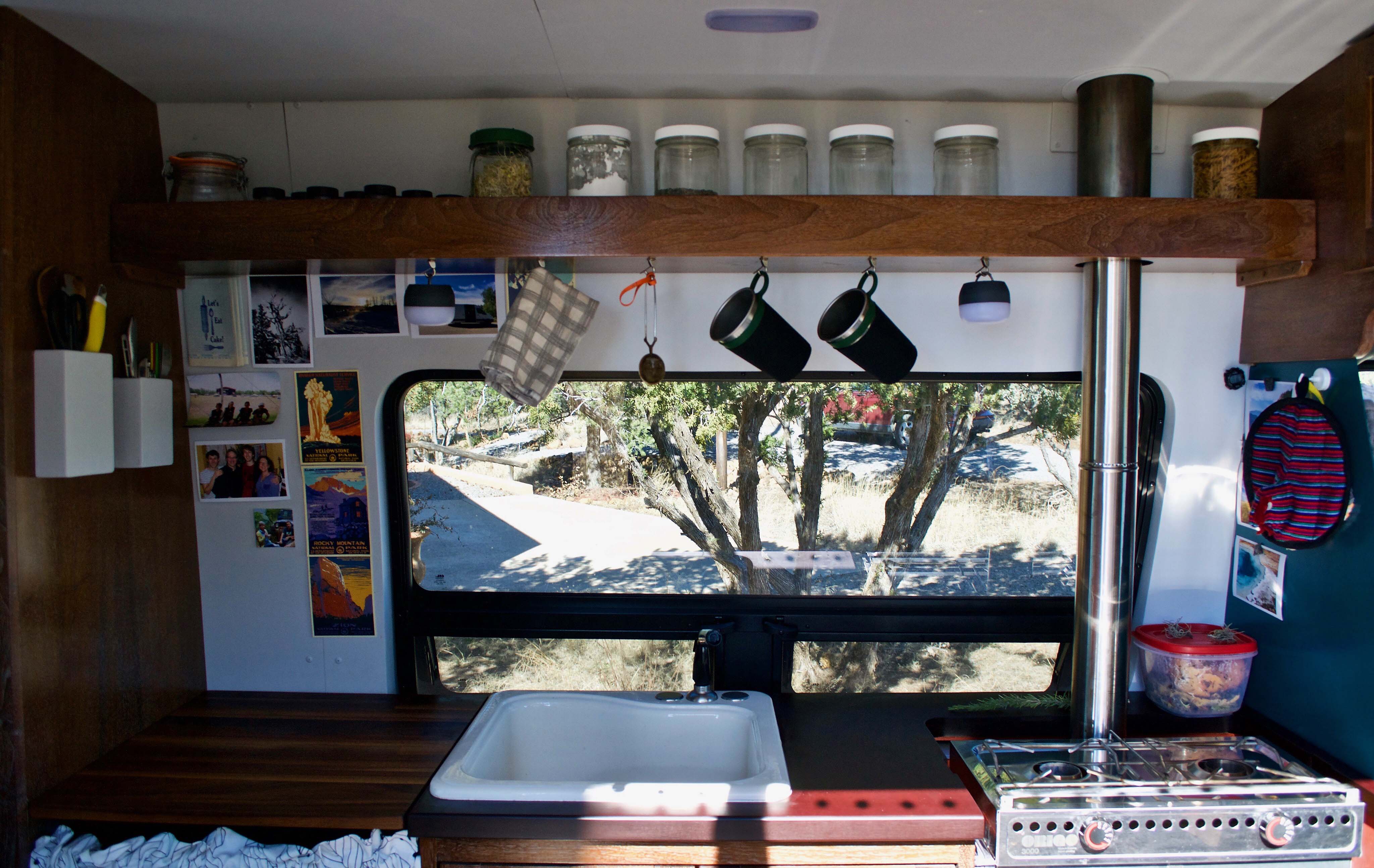 Inside a van with a little kitchenette and essentials.