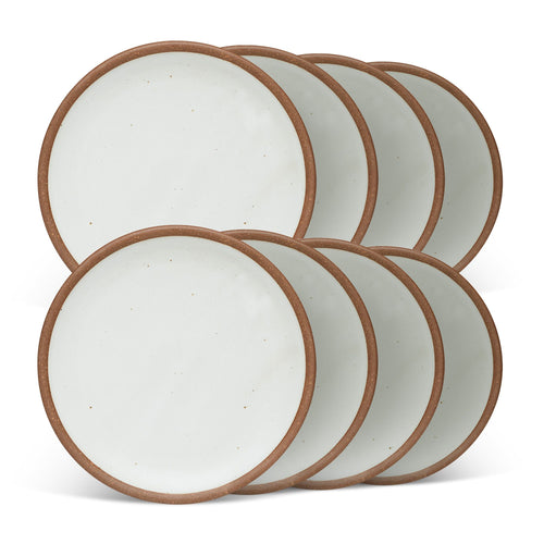 8 medium sized ceramic plates in a cool white color featuring iron speckles and an unglazed rim.
