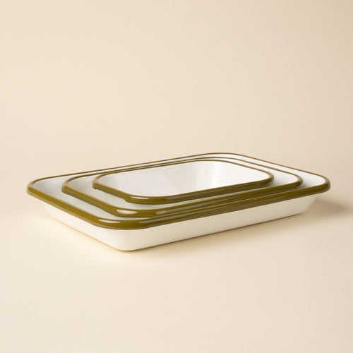 A nesting trio of small, medium, and large rectangular baking dishes in a white color with an olive green rim.