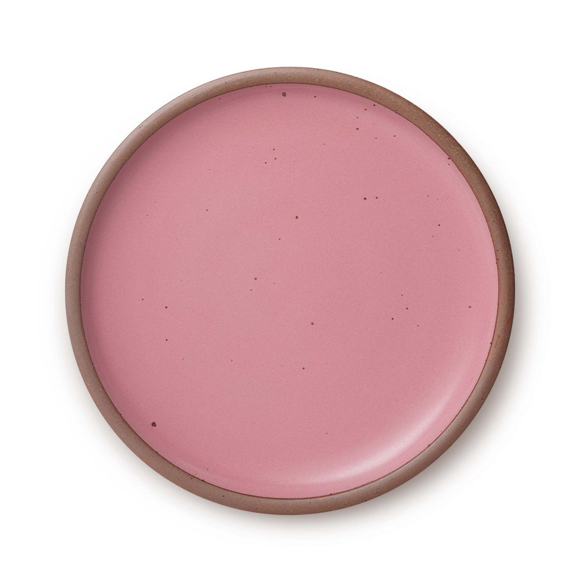 A large ceramic platter in a pink color featuring iron speckles and an unglazed rim.