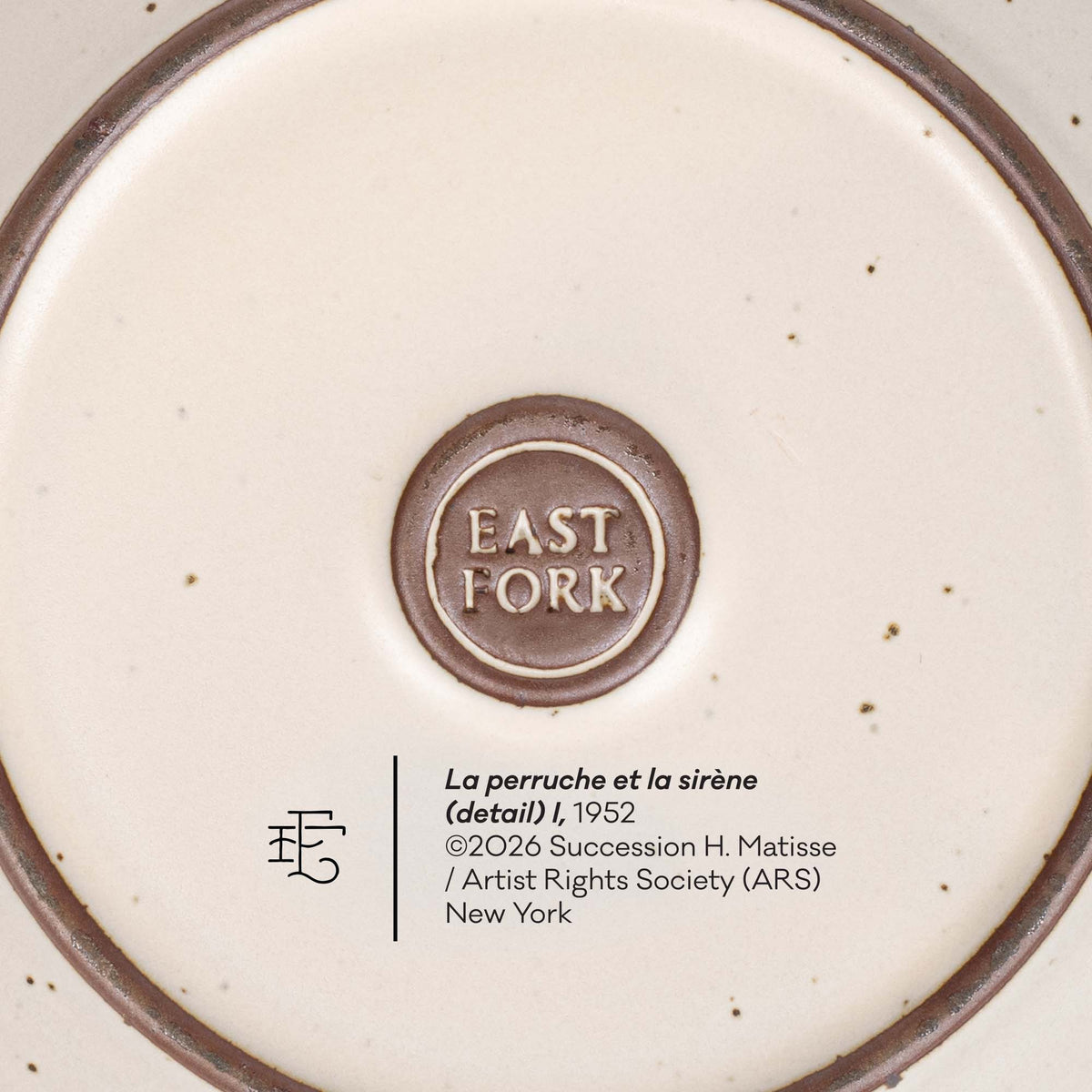 The back of a ceramic cake plate with an East Fork stamp with a small decal of information about the artwork.