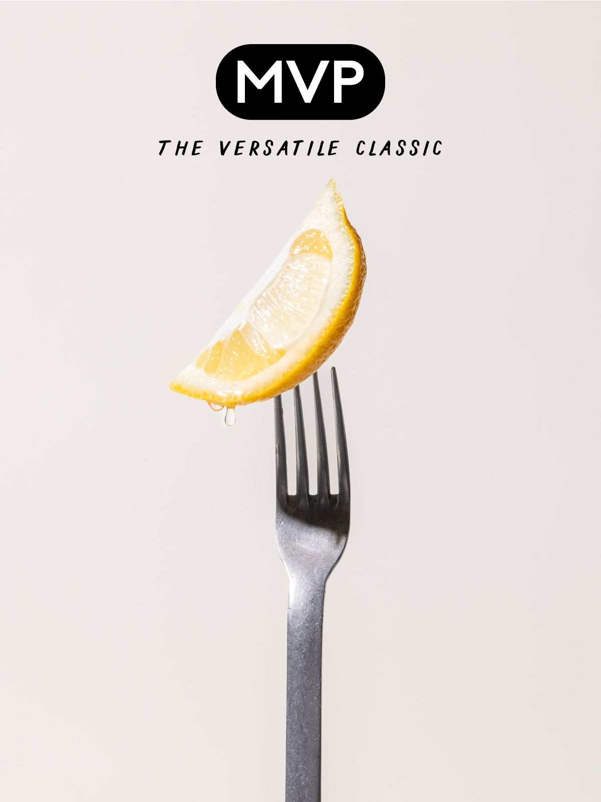A stainless steel fork with a lemon wedge on the prongs with text that reads 