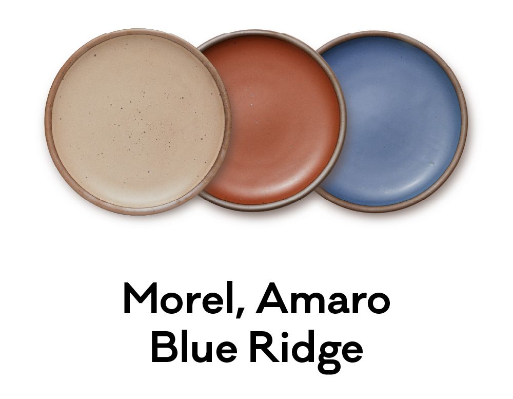 Three plates colored in a warm, earthy brown, a terra cotta red and a denim-like blue are positioned next to each other. Underneath, text reads: 