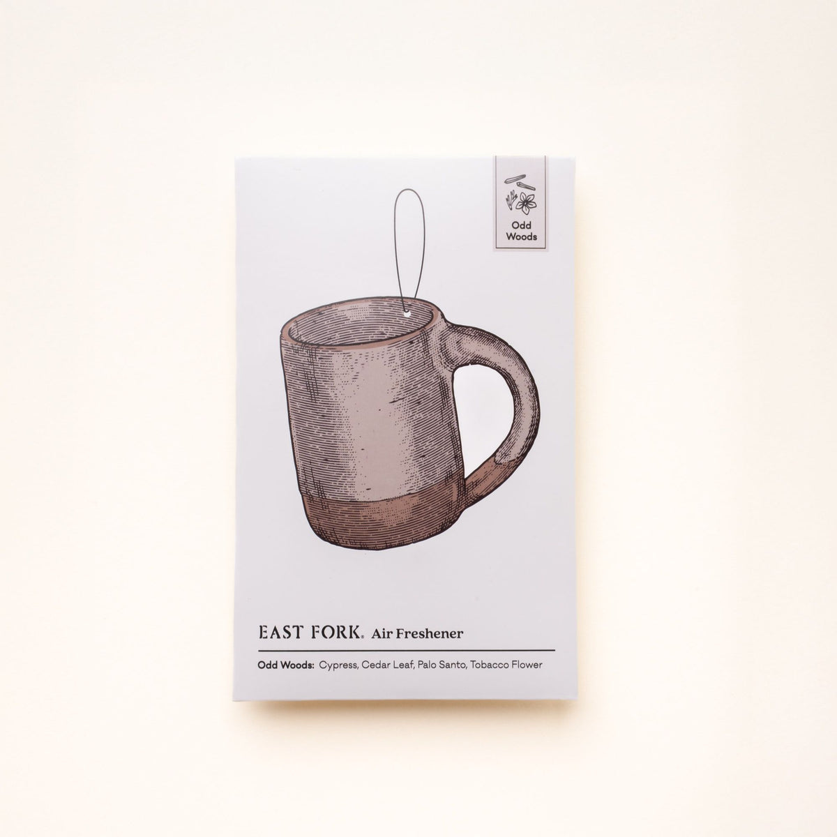 East Fork “Odd Woods” air freshener packaging featuring an illustrated mug and scent notes of cypress, cedar leaf, palo santo, and tobacco flower.