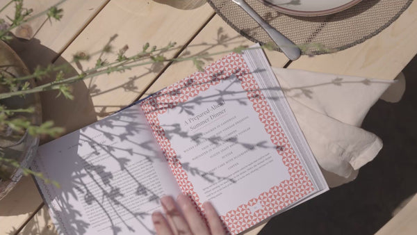 Video of Connie reading Taste of Country Cooking and then in her kitchen cooking and baking and setting a table filled with food.