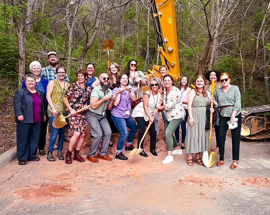 Staff picture of Helpmate with shovels and  a construction crane