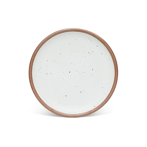 A dinner sized ceramic plate in a cool white color featuring iron speckles and an unglazed rim