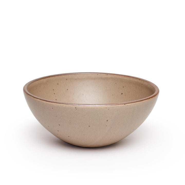 A large ceramic mixing bowl in a warm pale brown featuring iron speckles and an unglazed rim